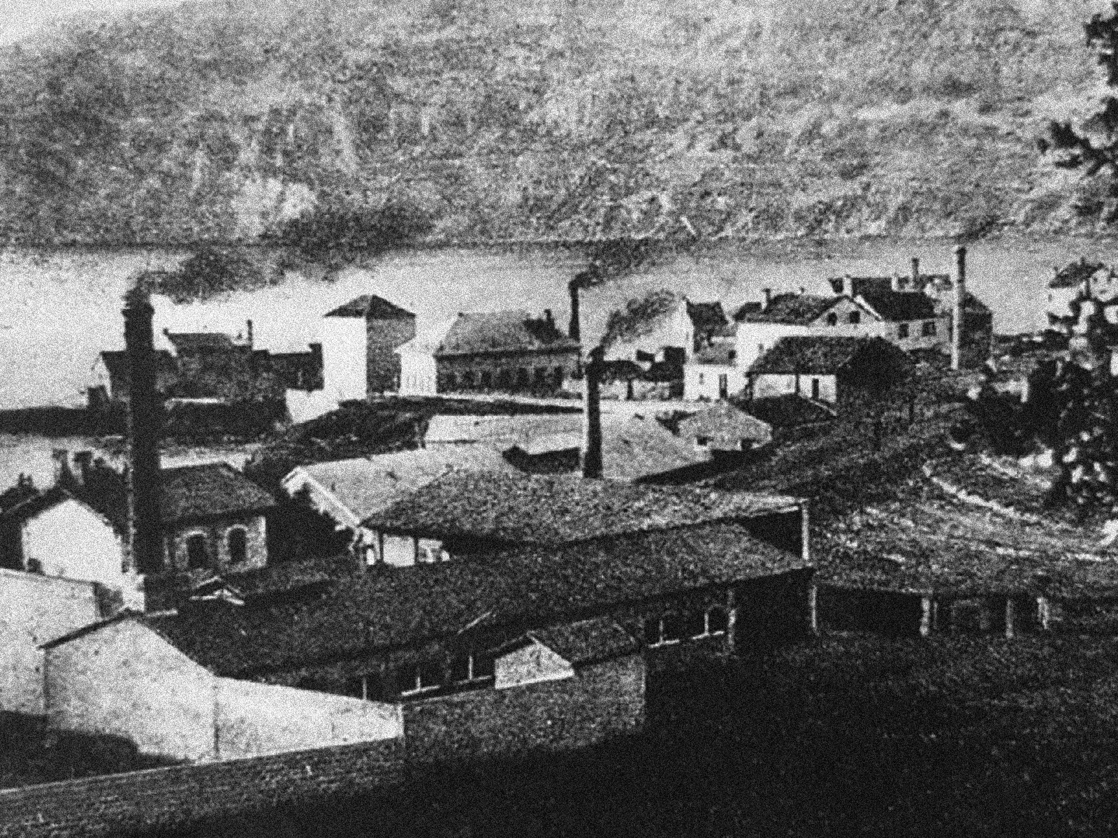 A coastal urban settlement, featuring some small factories and smoky brick chimneys.